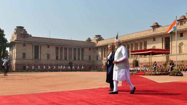 India's Prime Minister Narendra Modi, right, walks along with his Italian counterpart Giorgia Meloni during her ceremonial reception at presidential palace Rashtrapati Bhavan in New Delhi. Picture: AFP