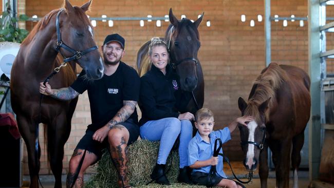 Former jockey Melinda Turner and husband Jason Turner with their five-year-old old nephew Qwade Kerr. Quade is with his pony Delight who was rescued by the pair. Picture: Nathan Edwards