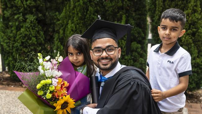Bachelor of Nursing graduate Harsh is congratulated by nephew Ayaan and niece Alisha Chahal at the UniSQ graduation ceremony at Empire Theatres, Tuesday, December 13, 2022. Picture: Kevin Farmer