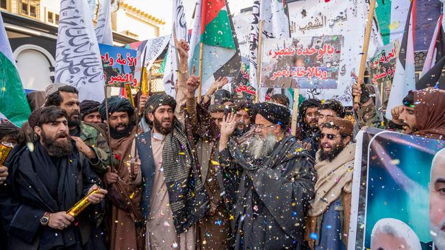 Taliban members holding Palestinian flags and banners in Kabul celebrate after the declaration of the Israel-Hamas ceasefire deal. Picture: AFP