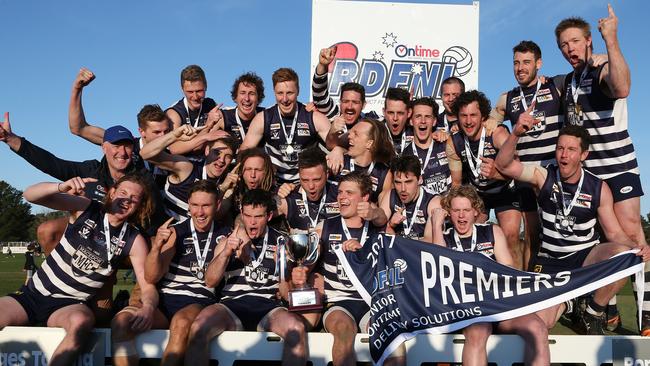 RDFL grand final: Macedon v Rupertswood. 16th September.   Macedon coach Jeff Andrews and captain James Wright hold aloft the premiership trophy as the Macedon team celebrates the win.Picture : George Salpigtidis