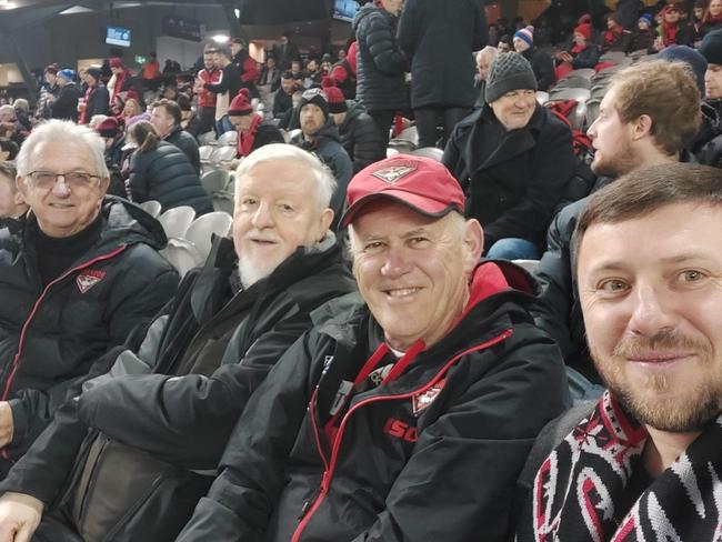 Cardinal Mykol Bychok, right, at his first AFL game.
