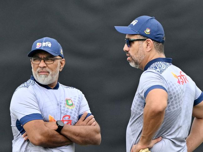 Bangladesh's head coach Chandika Hathurusingha (L) talks to bowling coach Andre Adams (R) during a practice session at the Zahur Ahmed Chowdhury Stadium in Chittagong on March 14, 2024, on the eve of the second one-day international (ODI) cricket match against Sri Lanka. (Photo by MUNIR UZ ZAMAN / AFP)