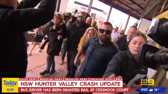 Brett Andrew Button’s family members leave court after the bus driver was granted bail. They clashed with waiting media before entering a car. Picture: Nine News