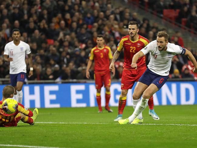 England's Harry Kane, right, scores the fifth goal during the Euro 2020 group A qualifying soccer match between England and Montenegro at Wembley stadium in London, Thursday, Nov. 14, 2019. (AP Photo/Kirsty Wigglesworth)