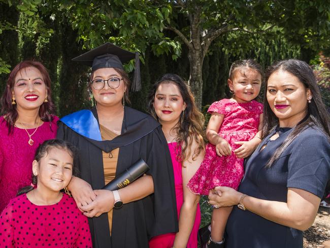 Graduate Sushila Duwal with family (from left) mum Subhadra Duwal, sister Shanvi Gaishe, sister Sandhya KC and aunt Sharmila Thapa holding Saira Gaishe at a UniSQ graduation ceremony at Empire Theatres, Tuesday, October 31, 2023. Picture: Kevin Farmer