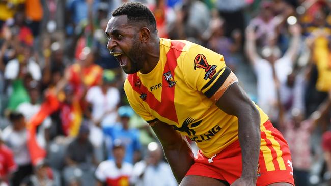 Wellington Albert celebrates after scoring a try for PNG. The Kumuls prop was earlier accused of biting.