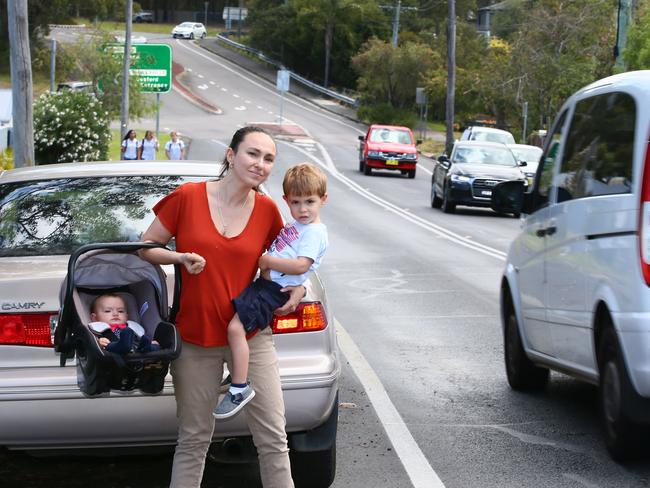 Danger zone: Laura Tasker, with her children, Isabella, 5 months, and Jacob, 2, struggles to safely cross Scenic Highway on Tuesday. Picture: Peter Clark