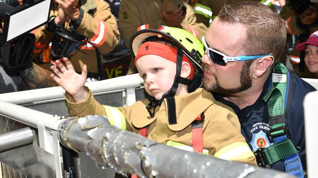 Make Alex's Day photographed in Rundle Mall, Adelaide on Friday the 23rd of February 2018. Alex will become the best firefighter ever, as he 'rescues' Port Adelaide' AFL player Travis Boak & Adelaide Crows' AFLW player Erin Phillips from the Beehive Corner building.  8-year-old Alex Tamm who, in 2012, who was diagnosed with a brain tumour and unfortunately lost his sight.  (AAP/ Keryn Stevens)