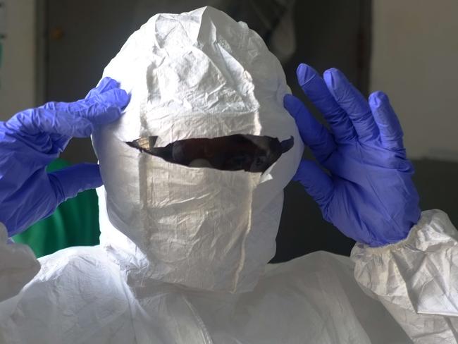 Medical workers of the John Fitzgerald Kennedy hospital of Monrovia wear their protective suit before going to the high-risk area of the hospital, the surgical section where Ebola patients are being treated, on September 3, 2014. Nurses at Liberia's largest hospital went on strike on September 1, 2014, demanding better pay and equipment to protect them against a deadly Ebola epidemic which has killed hundreds in the west African nation.AFP PHOTO / DOMINIQUE FAGET