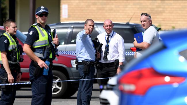 Police officers monitor the scene of the tattoo parlour shooting. Picture: AAP Image/Joe Castro