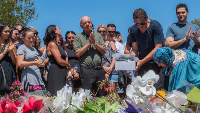 Aya Maasarwe’s father, Saeed, takes part in a vigil with family and friends at the site of her murder at Bundoora in northern Melbourne yesterday. Picture: Jason Edwards