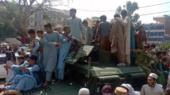 Taliban fighters and local people celebrating in Jalalabad. Picture: AFPTV