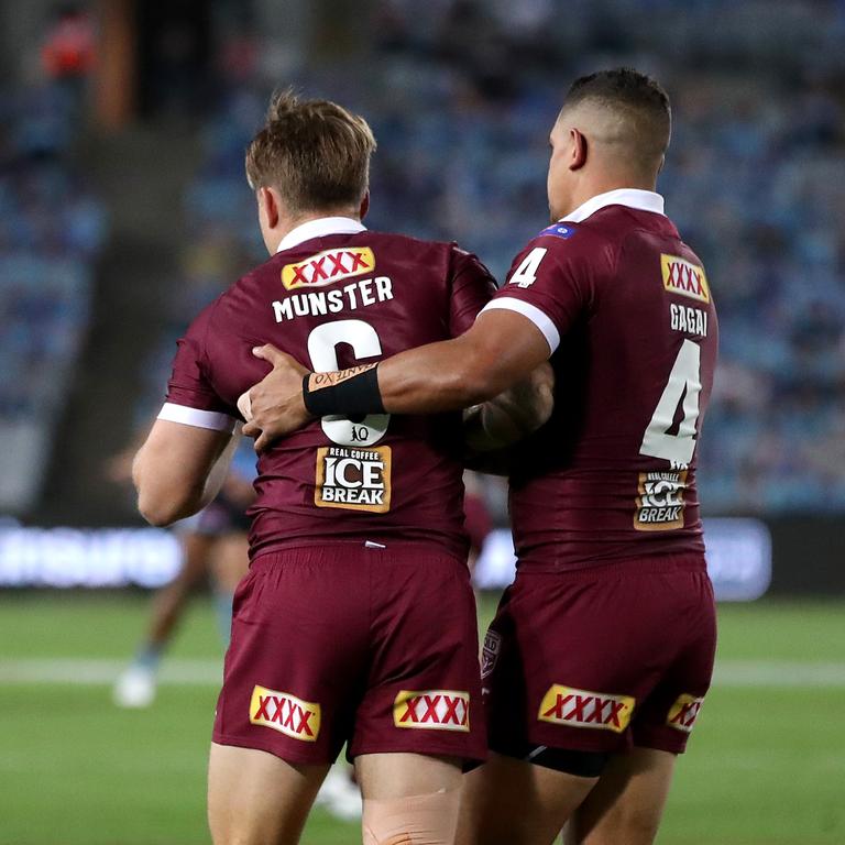 Cameron Munster helped up by Dane Gagai of the Maroons during game two of the 2020 State of Origin series. Picture: Cameron Spencer/Getty Images