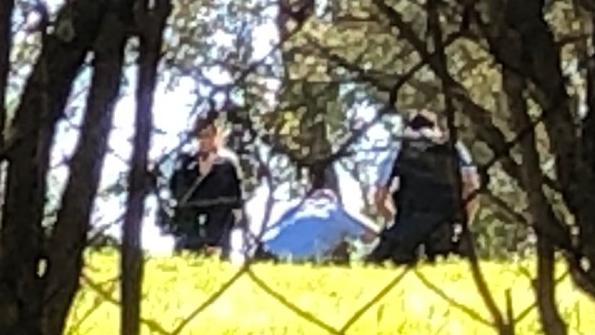 Police wrestle with the occupant of a semirural property at Belrose before using a Taser on him after the allegedly resisted officers and allegedly punched an officer in the face. Police allegedly found two guns and ammunition on the property after a fire in the carport. Picture: Jim O'Rourke