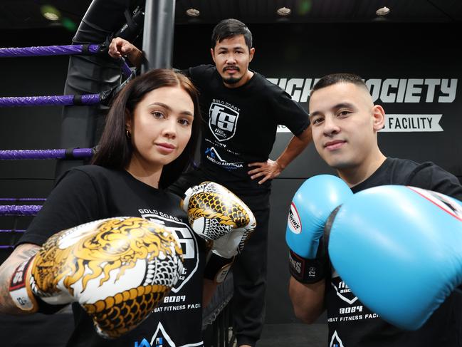 The Fight society opens this weekend at Nerang. Tegan Daly with partner and owner Brandon Baresic being watched over by coach Gob Teerawat.. Picture Glenn Hampson