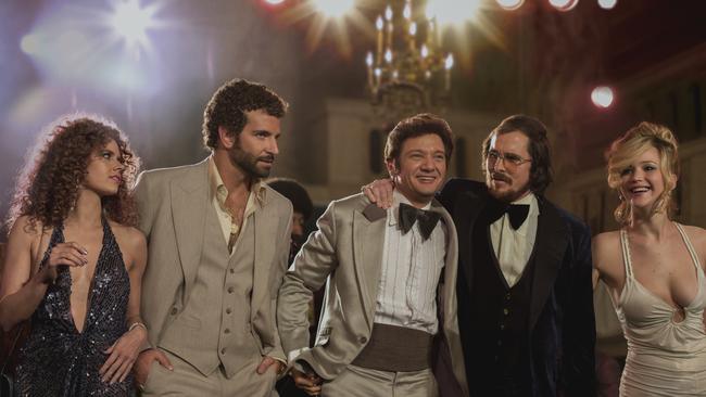 Amy Adams, as Sydney Prosser, Bradley Cooper, as Richie Dimaso, Jeremy Renner, as Mayor Carmine Polito, Christian Bale as Irving Rosenfeld, and Jennifer Lawrence as Rosalyn Rosenfeld in American Hustle.