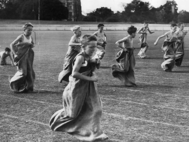 Athletics - Christian Brothers College (CBC) Sports Day at Adelaide.   N. Poore (nearest camera) wins the under-12 sack race.  Date Stamped 24 Apr 1947. (The Advertiser photograph Krischock)