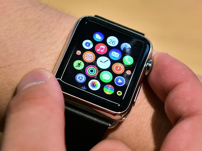 A South Korean employee shows the "Apple Watch" at an Apple shop in Seoul on June 26, 2015. Apple Watch on June 26 arrived in seven more countries including South Korea, Italy, Mexico, Singapore, Spain, Switzerland and Taiwan, after the US tech giant released its first smartwatch in April in nine countries including the United States, China and Japan. AFP PHOTO / JUNG YEON-JE