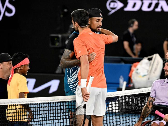 Serbia's Novak Djokovic (R) embraces Australia's Nick Kyrgios after their Arena Showdown charity match ahead of the Australian Open tennis tournament in Melbourne on January 13, 2023. (Photo by WILLIAM WEST / AFP) / --IMAGE RESTRICTED TO EDITORIAL USE - STRICTLY NO COMMERCIAL USE--