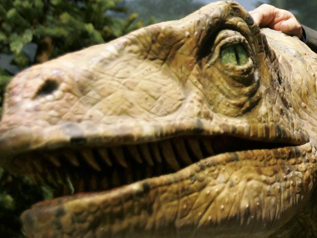 Ken Ham, founder of the nonprofit ministry Answers in Genesis, poses with one of his favorite animatronic dinosaurs during a tour of the new Creation Museum in Petersburg, Ky., Thursday, May 24, 2007. (AP Photo/Ed Reinke)