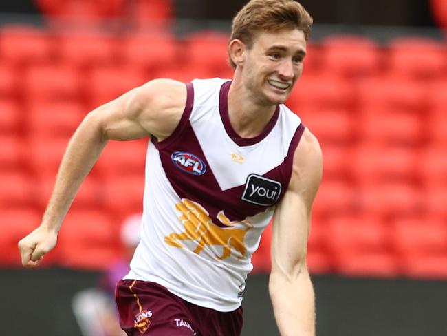 GOLD COAST, AUSTRALIA - FEBRUARY 25: Harris Andrews of the Lions handballs during the AFL practice match between Brisbane Lions and Adelaide Crows at Metricon Stadium on February 25, 2022 in Gold Coast, Australia. (Photo by Chris Hyde/Getty Images)