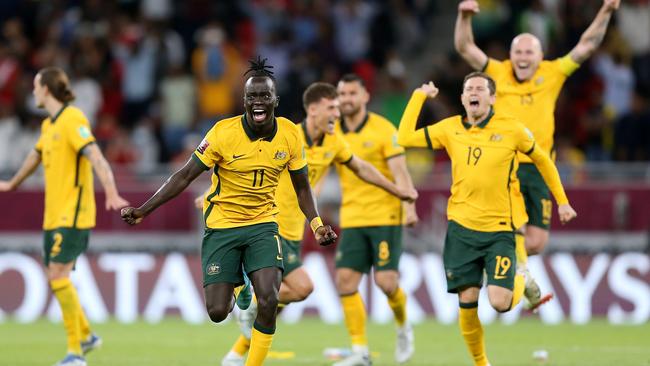 Qatar bound: Awer Mabil and teammates celebrate their win. Picture: Mohamed Farag/Getty Images