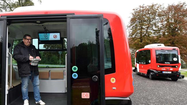 An operator stands inside a vehicle as the first German autonomous driving public transport buses start their service from the train station of Bad Birnbach, southern Germany, on October 7, 2019. - The self-driving public transport bus will bring passengers now from the train station to the town centre of Bad Birnbach, and back. The first autonomous minibus can transport six passengers and will travel on a partial public transport route of 2,040 meters in the small town of Bad Birnbach in Lower Bavaria. (Photo by Christof STACHE / AFP)