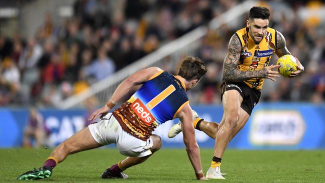 Chad Wingard of the Hawks runs past Ben Keays of the Lions during the round 11 match between Brisbane and the Hawks at The Gabba. Picture: Albert Perez/Getty Images