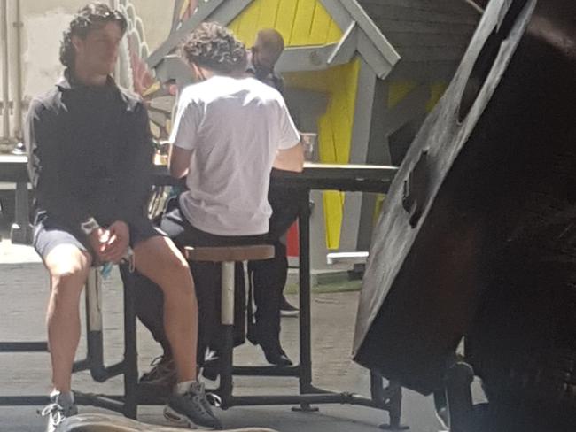 A man holds his mask in his hand at Barkly Square, Brunswick on Wednesday. Picture: Supplied via NCA NewsWire