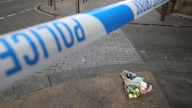 The first floral tributes to the victims of the terrorist attack are placed on the empty streets on Shudehill, in Manchester, England, following an explosion at Manchester Arena. Picture: Christopher Furlong / Getty