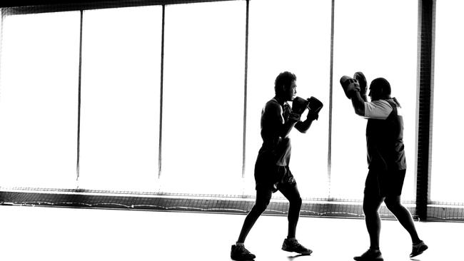 Jarrod Harbrow and boxing coach Tim Smith go through their paces.