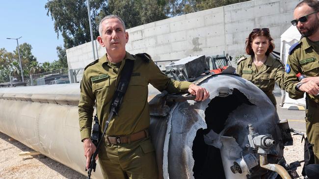 Israeli military spokesman Daniel Hagari poses next to an Iranian missile downed at the Julis military base near the southern city of Kiryat Malachi. Picture: AFP