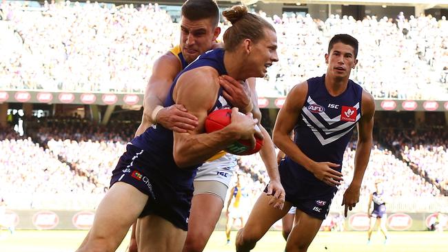 Nat Fyfe tries to break Elliot Yeo’s tackle.