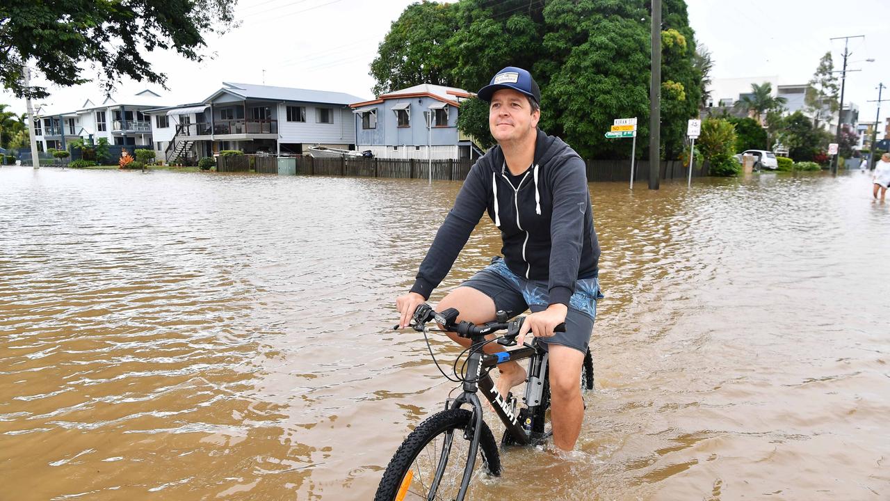 Bradman Ave remains closed as residents prepare for more rain and heavy flooding to hit the Sunshine Coast. Aaron Loats out for the morning ride. Picture: Patrick Woods.