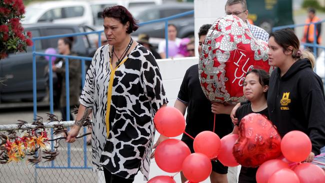 People arrive with balloons and messages of support as friends, relations, and local supporters gather on the quayside as the boat that carried families for a morning blessing at White Island returns to Whakatane. Picture: AAP