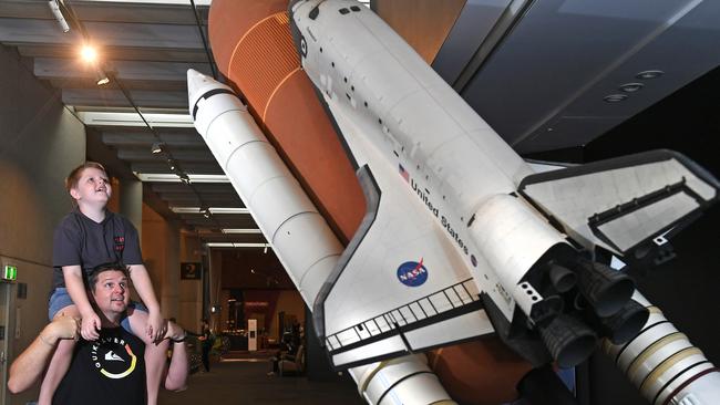 Nick Herbert and son Isaac Herbert, 11, check out NASA — A HUMAN ADVENTURE exhibition on now at the Queensland Museum. Photo: AAP/ John Gass)