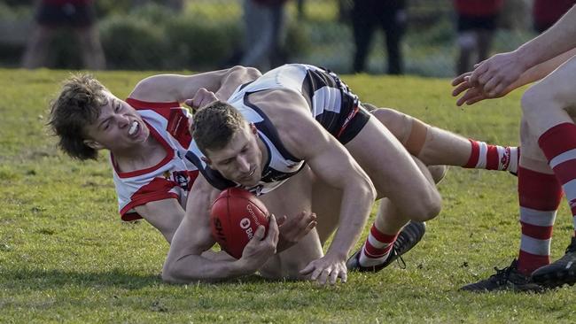 OEFL: Narre Warren’s Rhys Dempster can’t escape Olinda-Ferny Creek’s Jonty Scott. Picture: Valeriu Campan