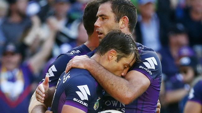 Cooper Cronk gets a hug from Cameron Smith after scoring a try.