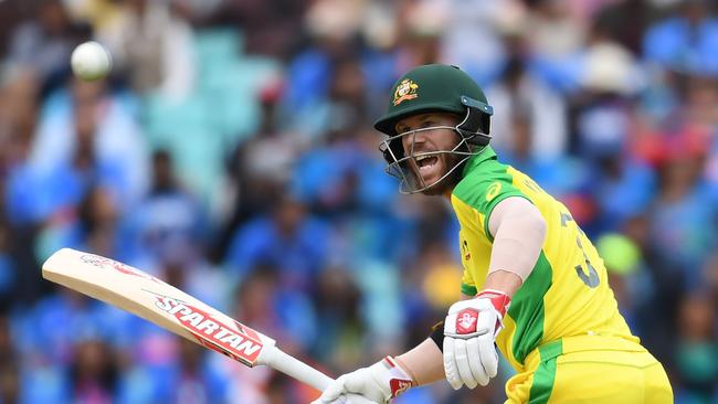 Australia's David Warner shouts after playing a shot during the 2019 Cricket World Cup group stage match between India and Australia at The Oval in London on June 9, 2019. (Photo by Dibyangshu SARKAR / AFP) / RESTRICTED TO EDITORIAL USE