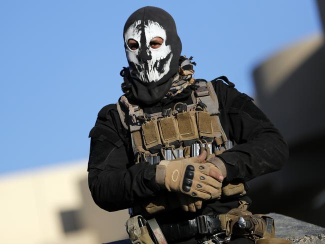 A member of the Iraqi Special Forces stands wearing a skull mask. Picture: AFP / Thomas Coex