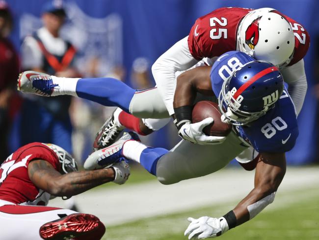 Arizona Cardinals cornerback Jerraud Powers (25) tackles New York Giants wide receiver Victor Cruz (80).