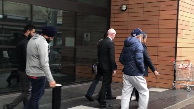 Harjinder Singh's supporters and legal representatives leave Blacktown Court at an earlier appearance.