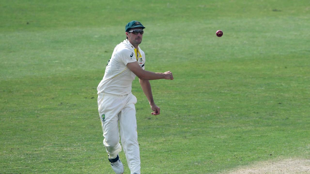 Australia's captain Pat Cummins fields the ball during the fifth day of the first Test cricket match between Pakistan and Australia at the Rawalpindi Cricket Stadium in Rawalpindi on March 8, 2022. (Photo by Aamir QURESHI / AFP)