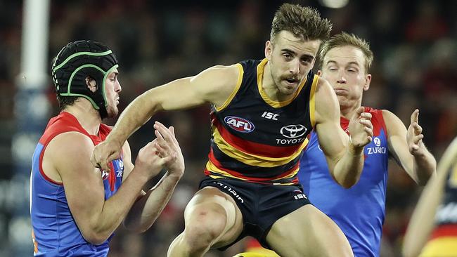 28/07/18 - AFL - Round 19 - Adelaide Crows v Melbourne at the Adelaide Oval. Jordan Gallucci plays tunnel ball with the ball between Angus Brayshaw and Bernie Vince. Picture SARAH REED