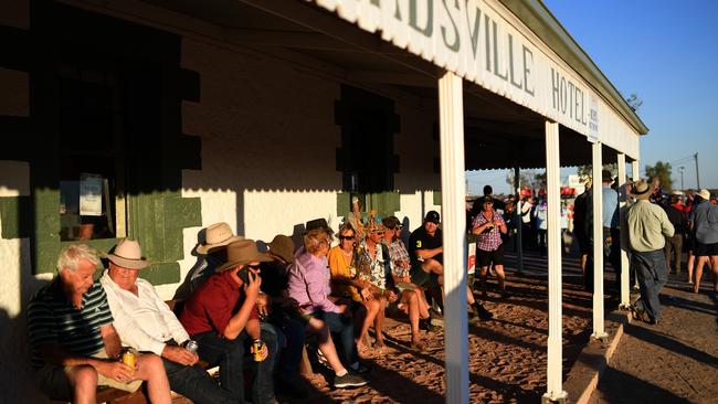 Pubgoers sit outside the Birdsville Hotel. Picture: AAP