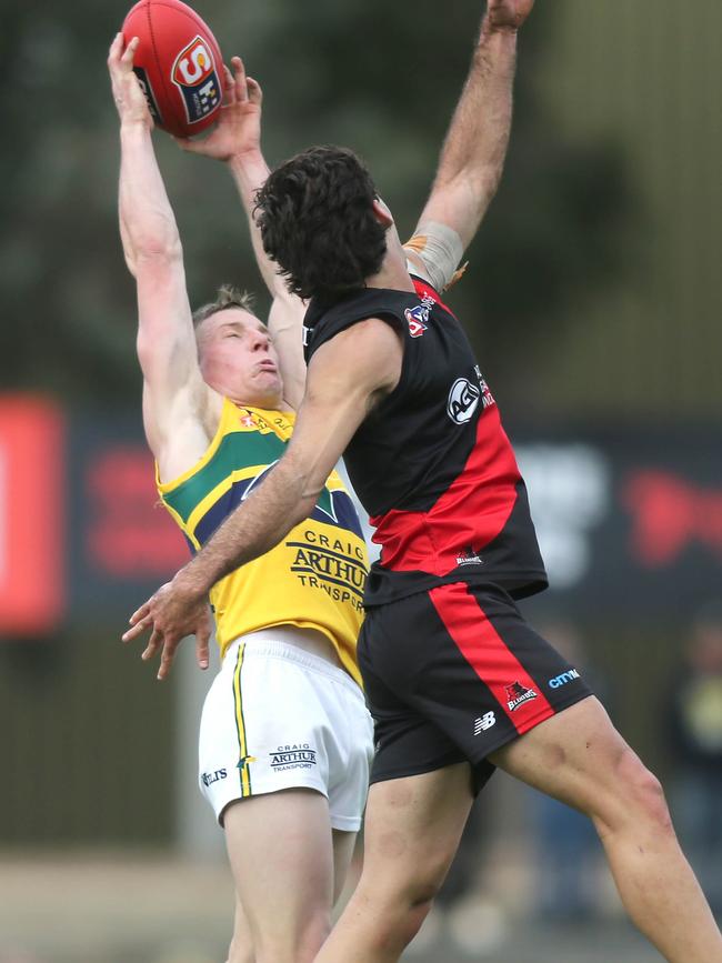 Eagles captain Joseph Sinor leaps high over West Adelaide’s Owen Mulady to mark at Richmond Oval on Saturday. Picture: Dean Martin.