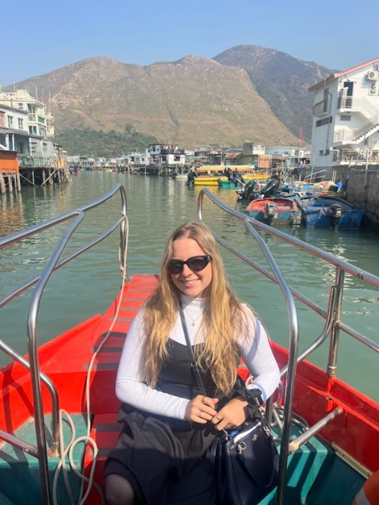 Journalist Crystal Fox on a boat ride through Tai O fishing Village in Hong Kong