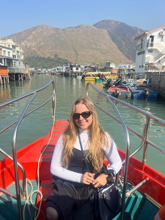 Journalist Crystal Fox on a boat ride through Tai O fishing Village in Hong Kong