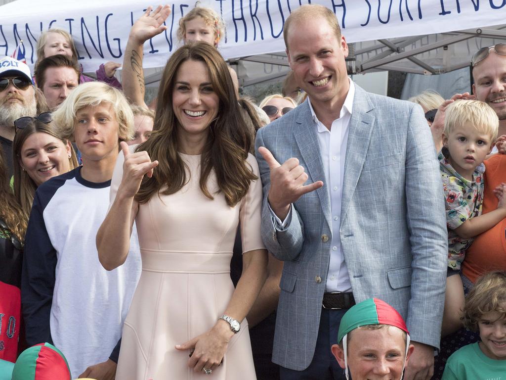 The Duke and Duchess of Cambridge perform a “Shaka” as they visit the Wave Project on September 1, 2016 in Newquay, United Kingdom. Picture: Splash